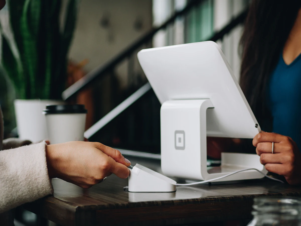 A credit card next to a phone, representing in-app payments