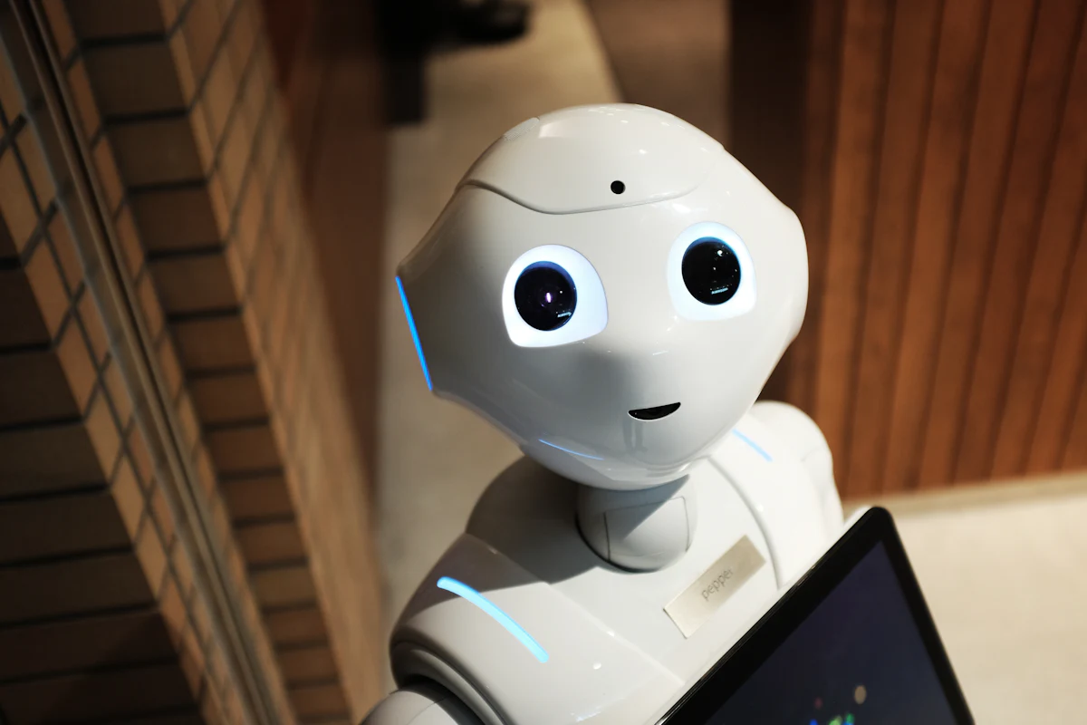 A robot figure on a soft pastel background, representing studio social automation